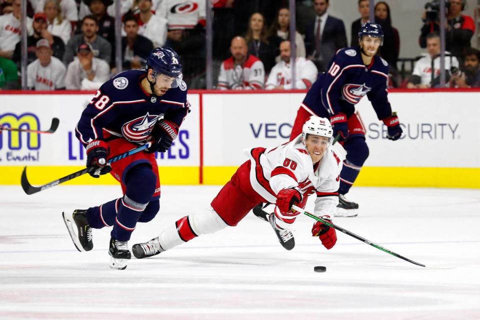 Carolina Hurricanes’ Teuvo Teravainen (86) dives at the puck controlled by Columbus Blue Jackets’ Oliver Bjorkstrand (28) during the third period of an NHL hockey game, in Raleigh, N.C., Saturday, Oct. 12, 2019.