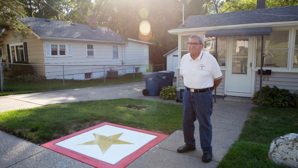 Frank Pompa stands outside his childhood home, one of the original boxcar homes still on the street. (Zamone Perez/Staff)