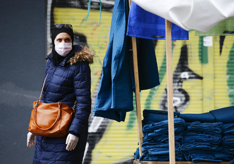 BERLIN, GERMANY - APRIL 14: People, wearing medical masks as a precaution against the new type of coronavirus (COVID-19) pandemic, shop at marketplace in Berlin's Kreuzberg known as the district where the Turks live the most in Germany on April 14, 2020. Coronavirus measures were also implemented at the market place established in Kreuzberg. (Photo by Abdulhamid Hosbas/Anadolu Agency via Getty Images)