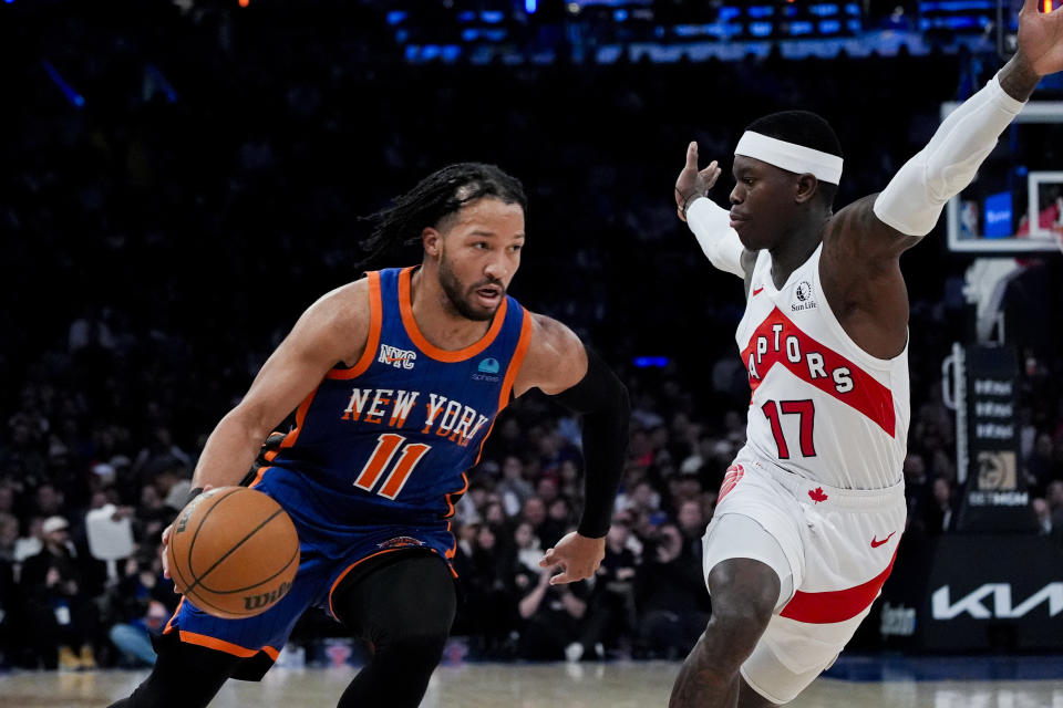 New York Knicks guard Jalen Brunson (11) drives to the basket against Toronto Raptors guard Dennis Schroder (17) during the first half of an NBA basketball game in New York, Saturday, Jan. 20, 2024. (AP Photo/Peter K. Afriyie)