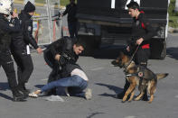 Police officers detain a person as thousands of supporters of pro-Kurdish Peoples' Democratic Party, or HDP, gathered to celebrate the Kurdish New Year and to attend a campaign rally for local elections that will test the Turkish president's popularity, in Istanbul, Sunday, March 24, 2019. The HDP held the event amid the municipal office races that have become polarizing and a government crackdown on its members for alleged links to outlawed Kurdish militants. (AP Photo/Emrah Gurel)