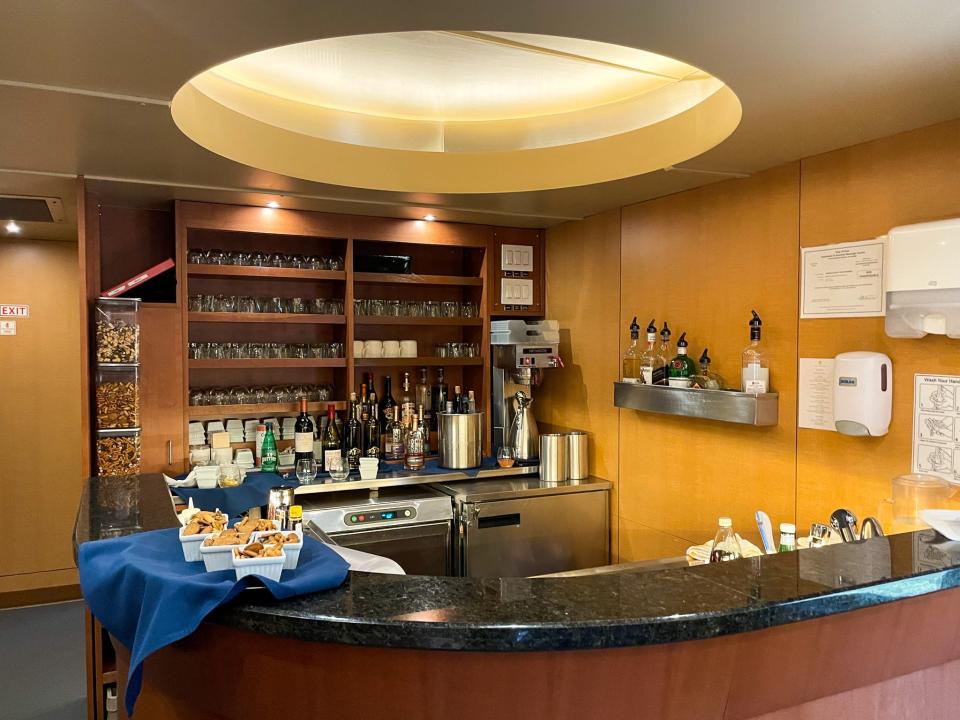 Rows of glass and mugs fill the wall behind the bar.