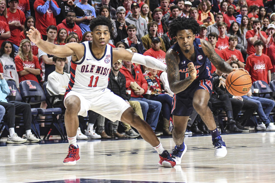 Auburn guard Zep Jasper (12) drives past Mississippi guard Matthew Murrell (11) during the first half of an NCAA college basketball game in Oxford, Miss., Saturday, Jan. 15, 2022. (AP Photo/Bruce Newman)