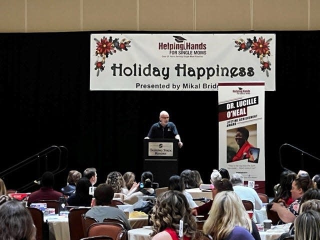 Chris Coffman, founder of Helping Hands for Single Moms, speaks at the "Holiday Happiness" event at Talking Stick Resort and Casino on Dec. 3, 2022.