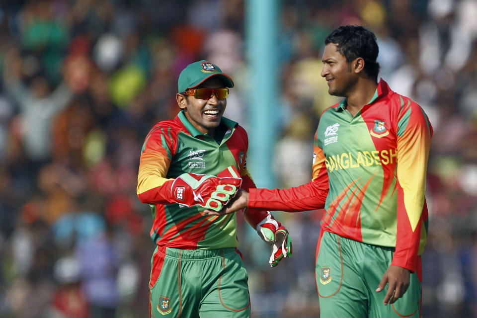 Bangladesh’s Shakib Al Hasan, right, celebrates with Mushfiqur Rahim after taking the wicket of Andrew Poynter during a warm up cricket match between them ahead of the ICC World Twenty20 Cricket tournament in Fatullah, near Dhaka, Bangladesh, Friday, March 14, 2014. (AP Photo/A.M. Ahad)