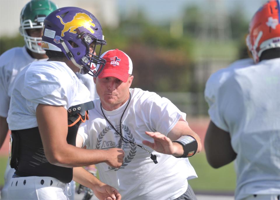 Stephenville coach Sterling Doty works with linemen during the Red Team practice Friday at Wylie.