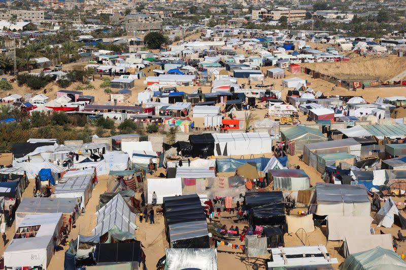 Displaced Palestinians shelter in a tent camp in Rafah