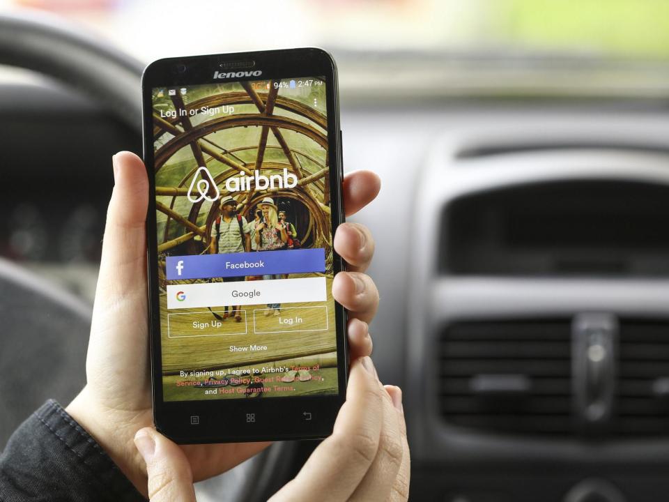 Close-up of a smartphone with the Airbnb app login screen: Getty