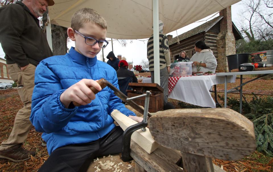 Thirteen-year-old Caleb Poulson works to make a wooden mallet during the Spirit of Christmas Past event held Saturday, Dec. 3, 2022, at the Kings Mountain Historical Museum.