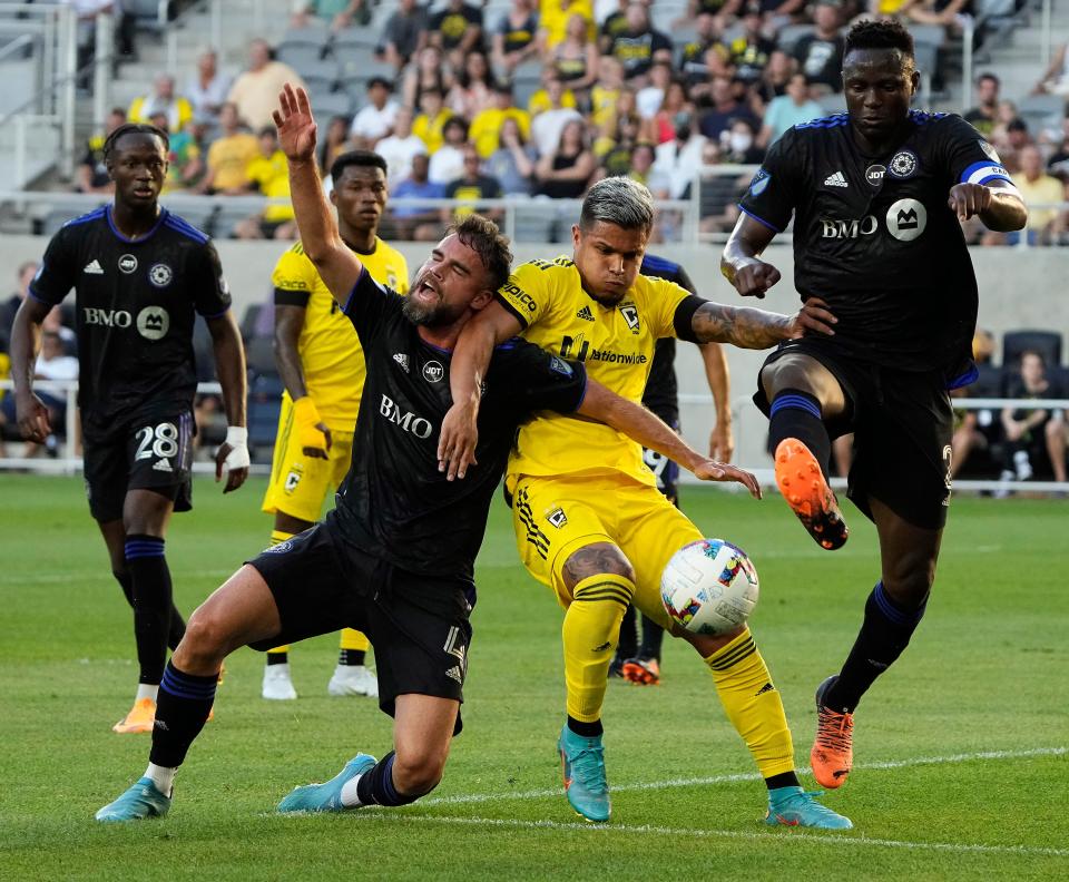 Center back Rudy Camacho, left and then playing for Montreal CF, battles Crew forward Cucho Hernandez for the ball during a 2022 game.