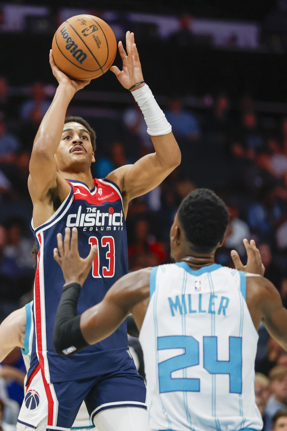 Washington Wizards guard Jordan Poole (13) shoots over Charlotte Hornets forward Brandon Miller (24) during the first half of an NBA basketball game in Charlotte, N.C., Wednesday, Nov. 8, 2023. (AP Photo/Nell Redmond)