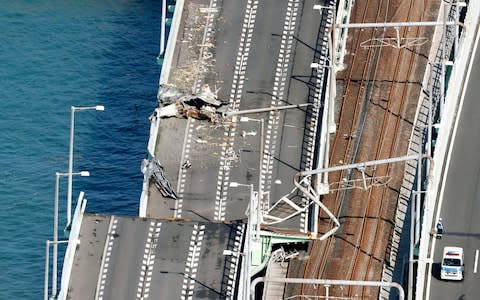 A damaged bridge that connects Kansai International Airport in Osaka, western Japan - Credit: AP