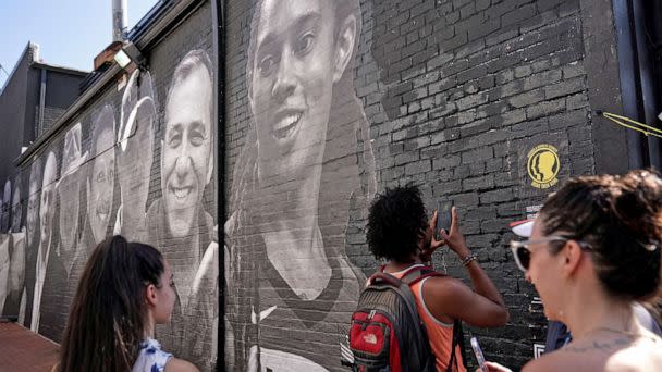 PHOTO: People visit a mural depicting photos of American hostages around the world, created by the Bring Our Families Home Campaign, is seen in the Georgetown neighborhood of Washington, D.C., July 20, 2022. (Sarah Silbiger/Reuters)