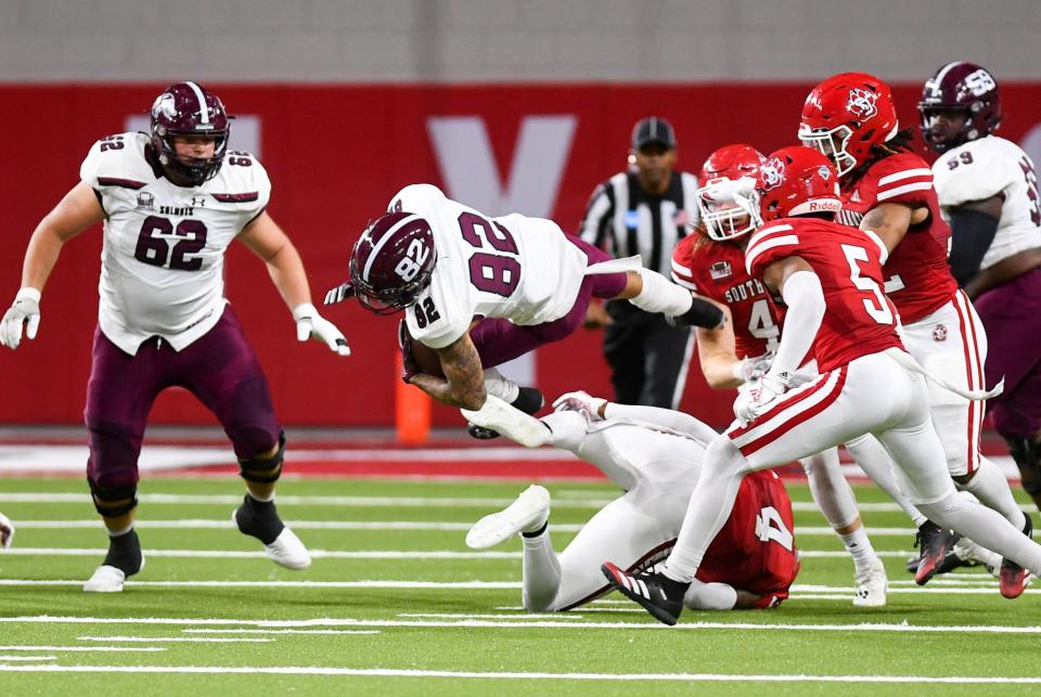 Southern Illinois' Izaiah Hartrup becomes airborne while avoiding a tackle by South Dakota during the FCS playoff game on Saturday, November 27, 2021, at the DakotaDome in Vermillion.