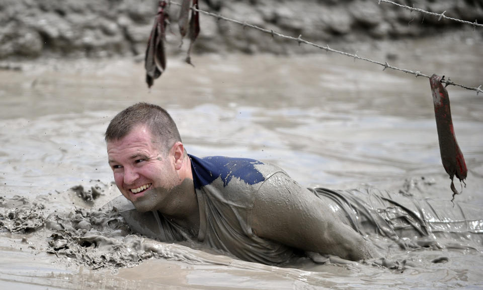 In this June 17, 2012 photo, Jeffrey Boehmer makes his way through the Muddy Mayhem obstacle at the Warrior Dash at Pocono Raceway in Long Pond, Pa. Virtually overnight, obstacle courses have become a favorite diversion of thrill-seekers and weekend warriors. (AP Photo/Scranton Times & Tribune, Melissa Evanko) WILKES BARRE TIMES-LEADER OUT; MANDATORY CREDIT