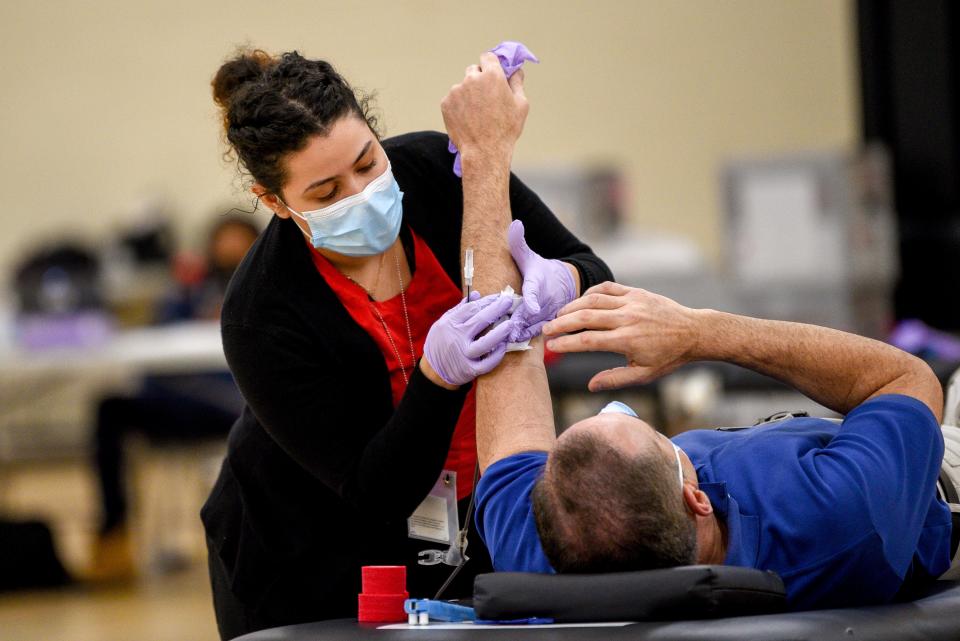 The Meadowlands YMCA in East Rutherford holds a blood drive with the Red Cross on Tuesday April 28, 2020. Janella Claudio, a DCA with Red Cross assists a blood donor. 