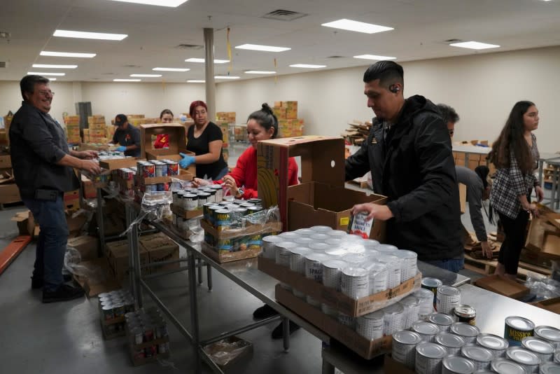 Employees and volunteers prepare relief boxes at the South Texas Food Bank in Laredo, Texas