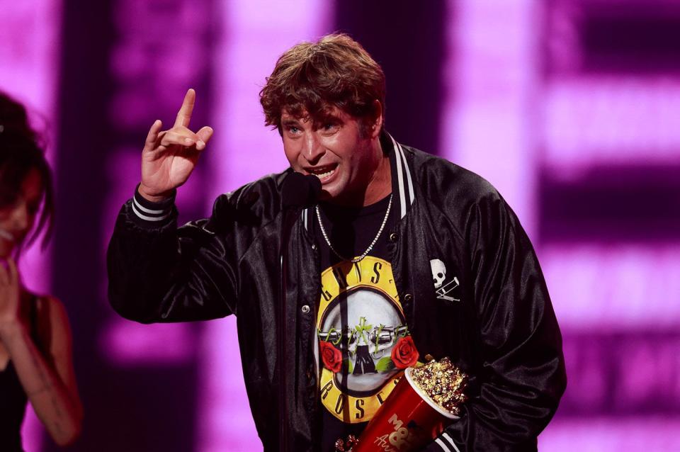 Actor Sean Poopies McInerney accepts the Best Kiss award for Jackass Forever during the MTV Movie and TV Awards at the Barker Hangar in Santa Monica, California, June 5, 2022. (Photo by Michael TRAN / AFP) (Photo by MICHAEL TRAN/AFP via Getty Images)