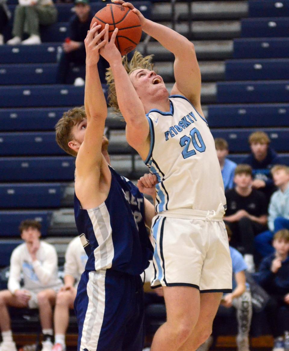 Petoskey's Korbin Sulitis (right) goes up for a basket while defended by Sault's Joey Gravelle in the second half.