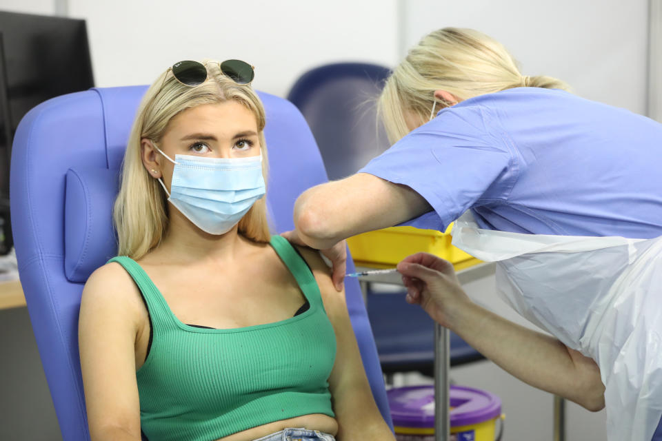 <p>17-year-old Danielle McIlroy, from Bangor, is given the last vaccination of the day during the The Big Jab Weekend at the vaccine clinic at the SSE Arena, Belfast. The weekend has seen walk-in vaccination centres opening again in Northern Ireland for first doses for all adults, amid concerns over the high number of Covid cases in the region. Picture date: Sunday August 22, 2021.</p>
