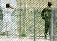 GUANTANAMO BAY, CUBA - AUGUST 26: A detainee looks into the window of a cell at Camp 4 inside of the maximum security prison Camp Delta at Guantanamo Naval Base August 26, 2004 in Guantanamo Bay, Cuba. This week the U.S. Military held preliminary hearings for four detainee's charged with conspiricy to commit war crimes. (Photo by Mark Wilson/Getty Images)