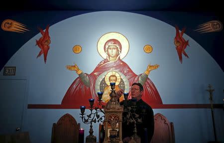 U.S. Republican presidential candidate Michael Petyo lights candles before the start of a reader service at Saint Nicholas Orthodox Church where he is a Cantor in Hobart, Indiana, United States, December 6, 2015. REUTERS/Jim Young