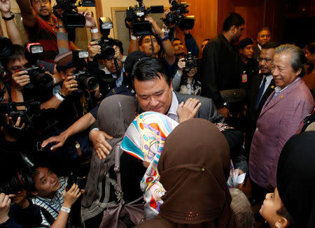 Mohd Nor Azrin Md Zain, counsellor at Malaysia's embassy in Pyongyang, hugs members of his family as he returns home from Pyongyang, at the Kuala Lumpur International Airport in Sepang, Malaysia. REUTERS/Lai Seng Sin