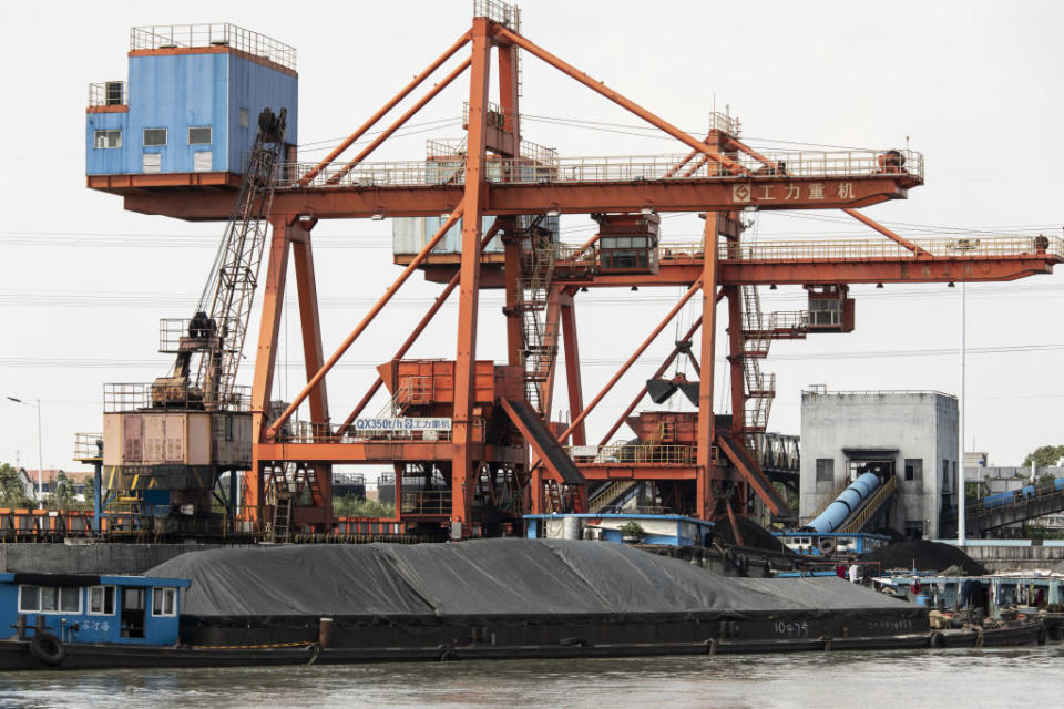 Coal is unloaded from barges at a dock servicing the Wangting Power Plant in Wangting, Jiangsu province, China, on Sept. 30, 2021. China's central government officials ordered the country's top state-owned energy companies -- from coal to electricity and oil -- to secure supplies for this winter at all costs, according to people familiar with the matter.<span class="copyright">Qilai Shen—Bloomberg/Getty Images</span>