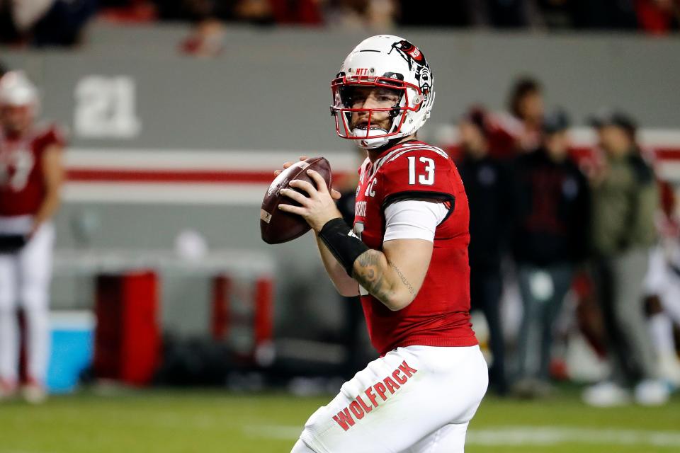 North Carolina State quarterback Devin Leary (13) looks to throw the ball against Syracuse during the second half of an NCAA college football game in Raleigh, N.C., Saturday, Nov. 20, 2021. (AP Photo/Karl B DeBlaker)