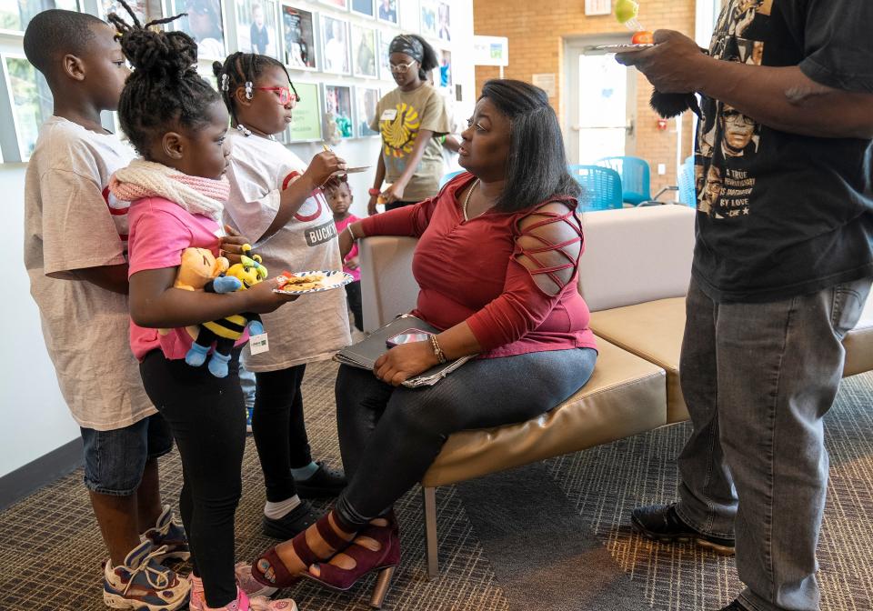 Ronna Dixon-Young speaks with family before a meeting with Jess Schnur on Sunday at Lifeline of Ohio offices. Dixon-Young was explaining to the children the importance of the meeting with Schnur, a nurse from Indiana who has an autoimmune disease and who received a liver from Dixon-Young's son, DeVille Deonte Morrow.