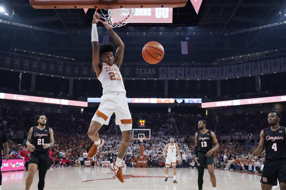 Texas forward Dillon Mitchell (23) scores against Houston during the second half of an NCAA college basketball game in Austin, Texas, Monday, Jan. 29, 2024. (AP Photo/Eric Gay)
