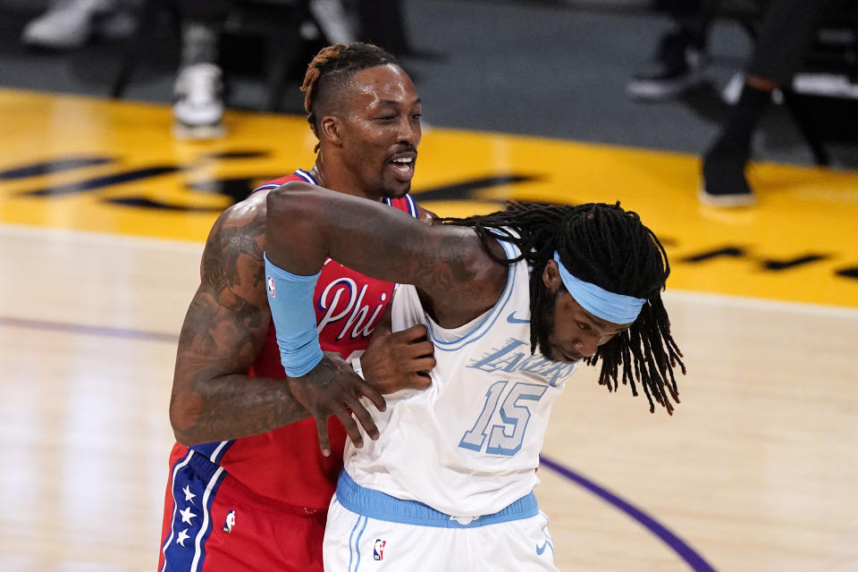 Philadelphia 76ers center Dwight Howard, left, and Los Angeles Lakers center Montrezl Harrell jockey for position during the first half of an NBA basketball game Thursday, March 25, 2021, in Los Angeles. (AP Photo/Mark J. Terrill)