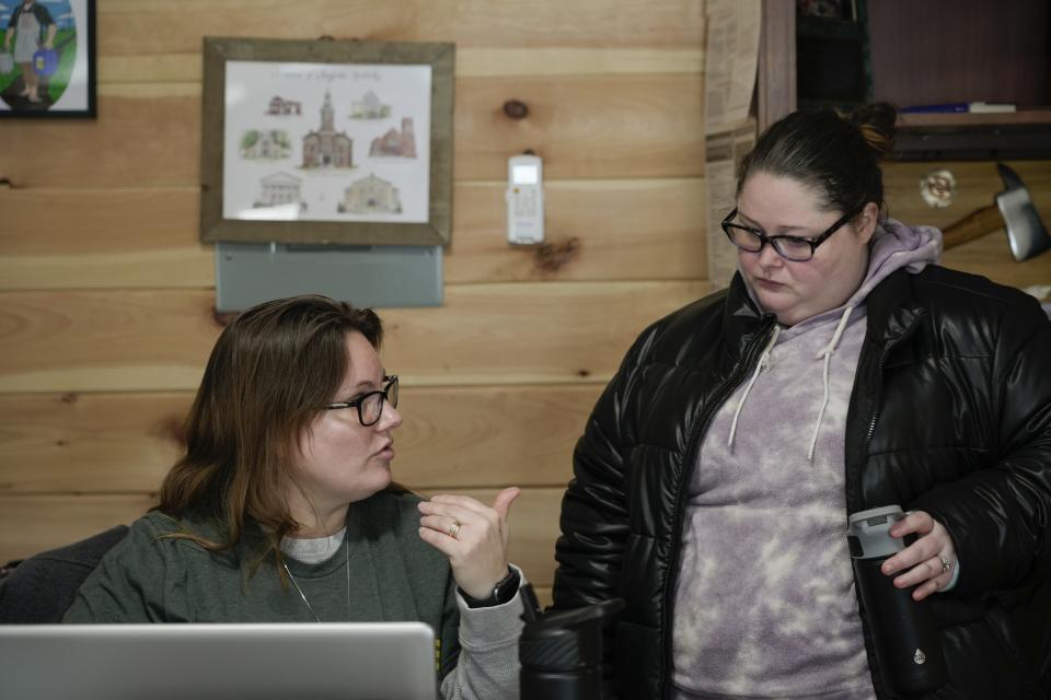 Cassy Basham, left, office manager at Camp Graves, a nonprofit helping provide temporary housing, talks with resident Ashley Prince, Monday, Jan. 15, 2024, in Water Valley, Ky. Basham says she does everything she can to make people feel supported in spite of the challenges they have faced. (AP Photo/Joshua A. Bickel)