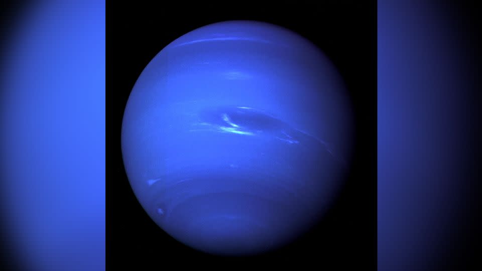 The "Great Dark Spot," a storm in Neptune's atmosphere, and the accompanying bright smudge of clouds are captured by the NASA Voyager 2 spacecraft less than five days before its closest approach to the planet on August 25, 1989. - NASA/JPL-Caltech/Handout/Reuters
