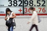 A person stands in front of an electronic stock board showing Japan's Nikkei 225 index at a securities firm Tuesday, April 30, 2024, in Tokyo. Asian shares mostly rose Tuesday, as investors kept their eyes on potentially market-moving reports expected later this week. (AP Photo/Eugene Hoshiko)