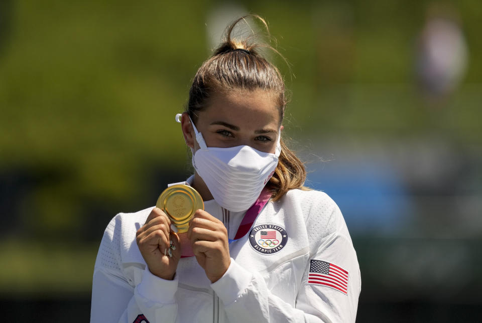 Nevin Harrison, of the United States, holds up her gold medal after winning the women's canoe single 200m final at the 2020 Summer Olympics, Thursday, Aug. 5, 2021, in Tokyo, Japan. (AP Photo/Lee Jin-man)