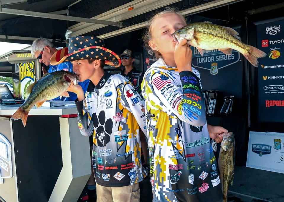 Dawson Turner and Ruby Caldwell kiss their bass fish after weighing in with an 5 pound, seven ounce second day catch, during the 2023 Bassmaster Junior National Championship at Green Pond Landing on Hartwell Lake. The duo from Anderson finished 28th, with a total two-day weight of 11 pounds, one ounce.