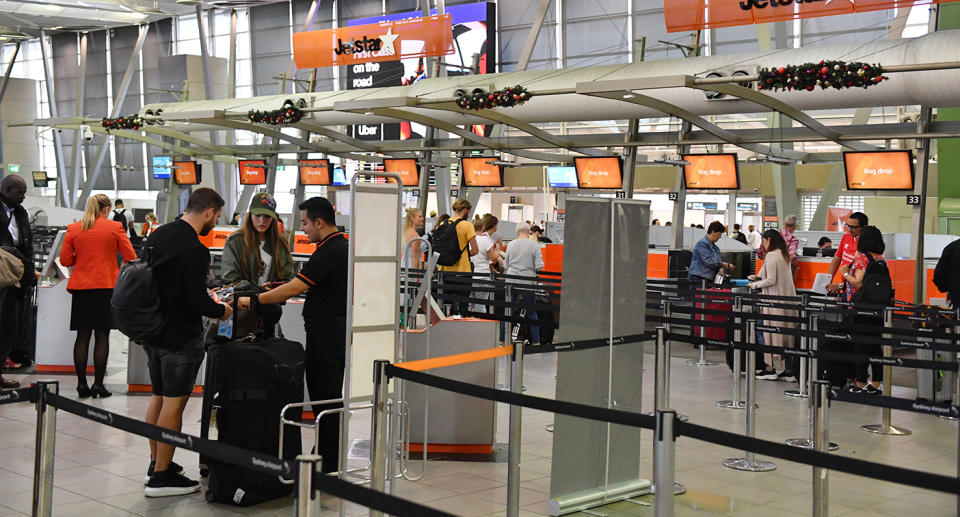 Passengers are seen at the Jetstar check in counters at Sydney Domestic Terminal in Sydney, Friday, December 13, 2019. Jetstar faces a weekend of strikes as baggage handlers and ground crew stop work followed by four-hour stoppages by pilots. (AAP Image/Mick Tsikas) NO ARCHIVING