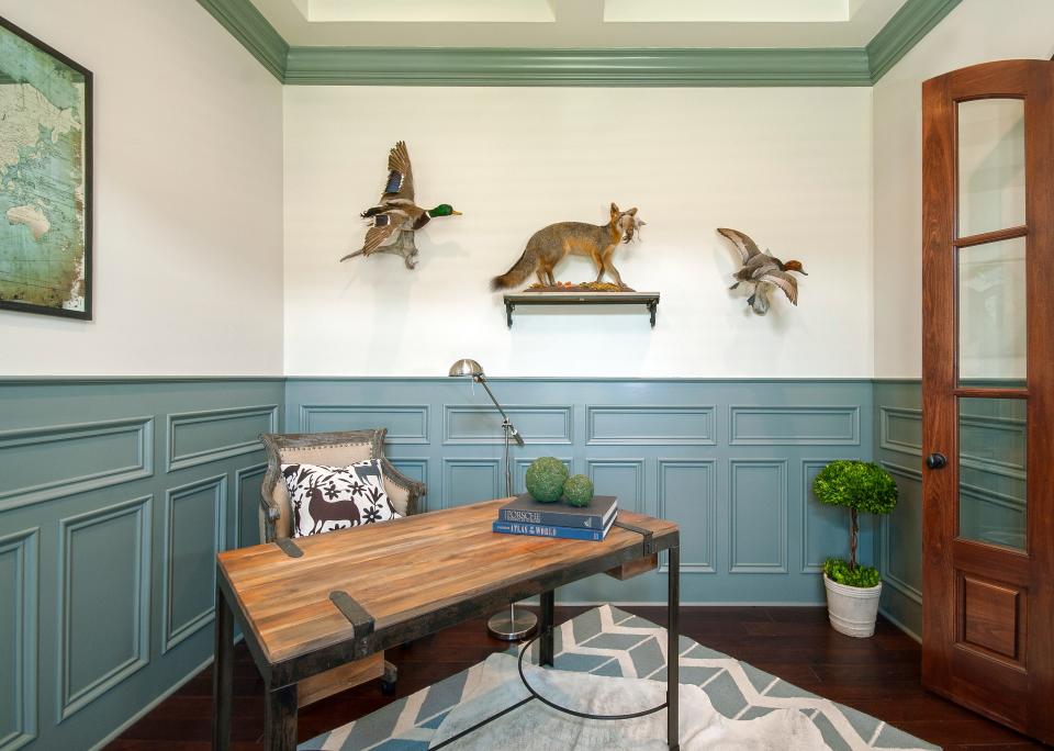 This home office that features an Italian writing desk,  taxidermy animals, hide over rug and antiqued mirror map art is inside a 6-bed, 3-and-a-half bath, traditional-style, two-story home in the Beech Spring Farm subdivision of East Louisville.