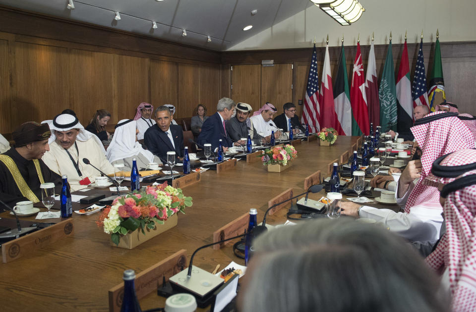 President Barack Obama sits at a long table during a meeting.