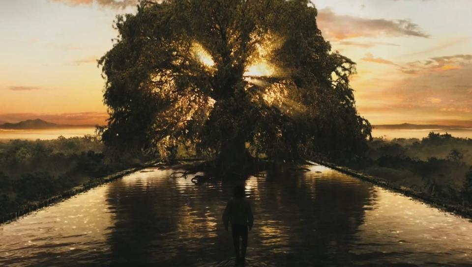 A figure walks on water toward a huge tree