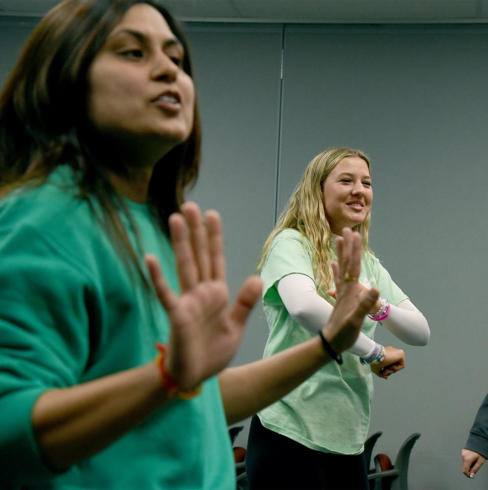 Dr. Khyati Petel lead the students in dancing to "I Follow" as part of dance therapy. Above, Monroe High School junior Emily Eshenroder dances at the #iMatter Youth Summit.