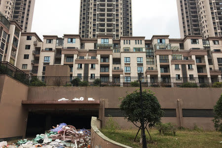 An abandoned residential area is seen near a construction site of an online gaming stadium in Zhongxian, Chongqing, China November 13, 2017. REUTERS/ Yawen Chen