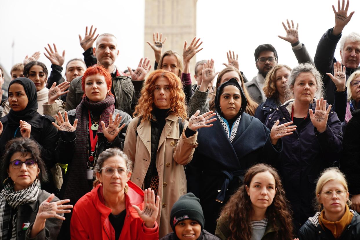 People take part in a vigil in Parliament Square, London, mourning children killed in Gaza (PA)