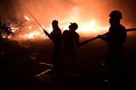 Firefighters and local residents try to extinguish the flames during a wildfire in Adames area, in northern Athens, Greece, Tuesday, Aug. 3, 2021.Thousands of people fled their homes north of Athens on Tuesday as a wildfire broke out of the forest and reached residential areas. The hurried evacuations took place just as Greece grappled with its worst heat wave in decades. (AP Photo/Michael Varaklas)