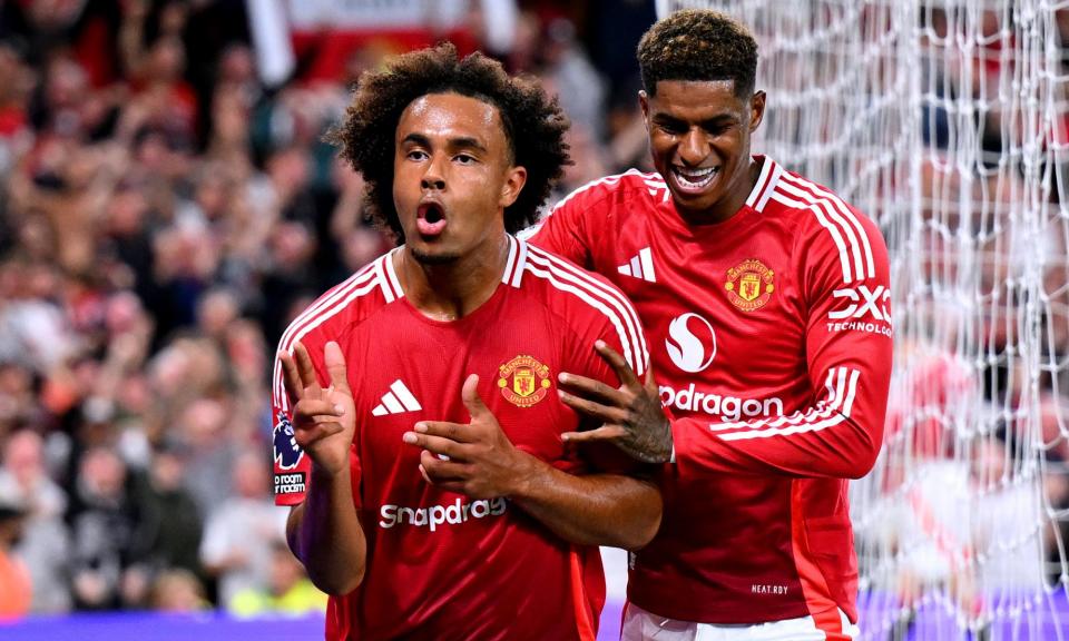 <span>Joshua Zirkzee celebrates scoring his first goal on his Manchester United debut alongside teammate Marcus Rashford.</span><span>Photograph: Michael Regan/Getty Images</span>