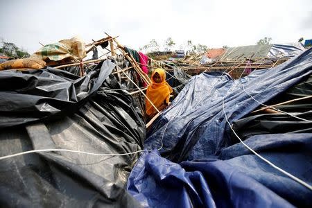 Ayesha, 16, a Rohingya refugee girl poses for a photograph in her house which has been destroyed by Cyclone Mora at Balukhali Makeshift Refugee Camp in Cox’s Bazar, Bangladesh May 31, 2017. REUTERS/Mohammad Ponir Hossain