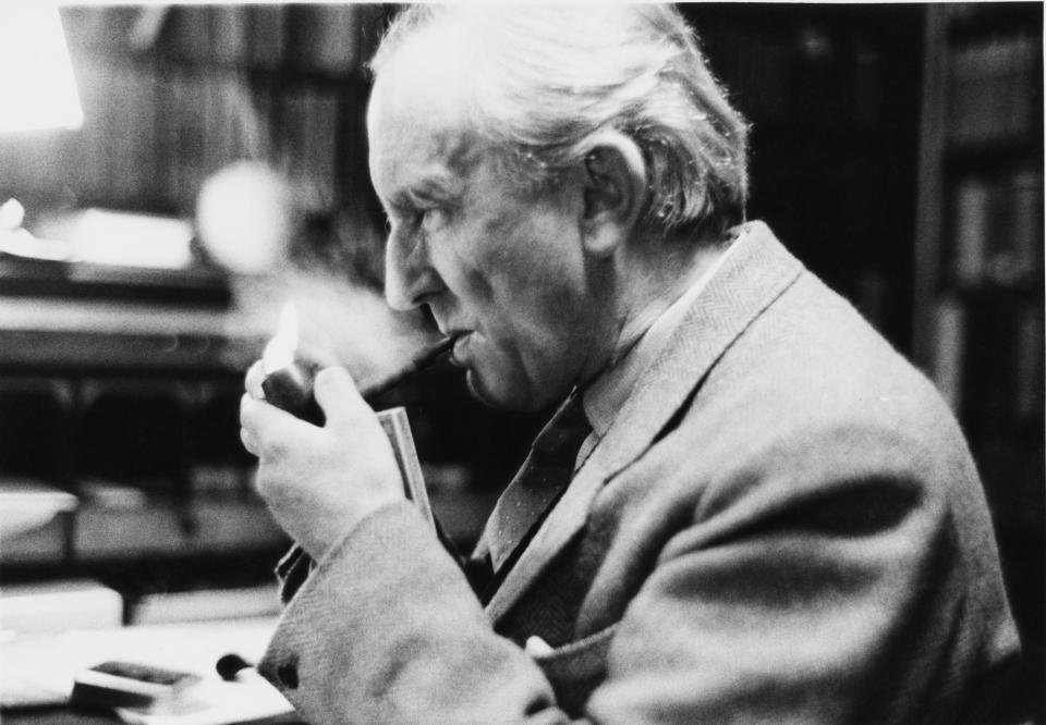 J. R. R. Tolkien smokes a pipe in his study at Merton College