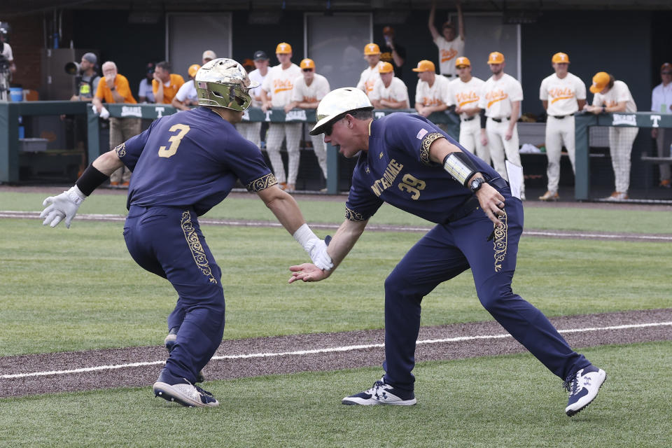 Notre Dame's David LaManna (3) is congratulated as he rounds third base after hitting a two-run home run against Tennessee in the seventh inning of an NCAA college baseball super regional game, Sunday, June 12, 2022, in Knoxville, Tenn. (AP Photo/Randy Sartin)