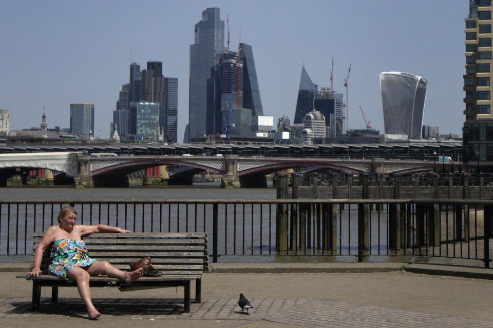 FILE - A woman sunbathes near the River Thames in front of a view of the City of London, on June 17, 2022. The U.K. sweltered through its hottest June since records began in 1884, the country’s weather agency said Monday, July 3, 2023, adding that human-induced climate change means such unusual heat will become more frequent in the next few decades. The average temperature for June in the U.K. hit 15.8 degrees Celcius ( Fahrenheit) — 0.9C hotter than the joint previous record of 14.9C in 1940 and 1976, according to the Met Office's provisional figures. (AP Photo/Kirsty Wigglesworth)